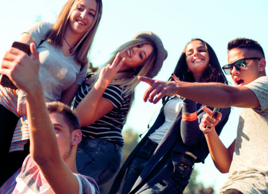 Best friends taking selfie outdoors