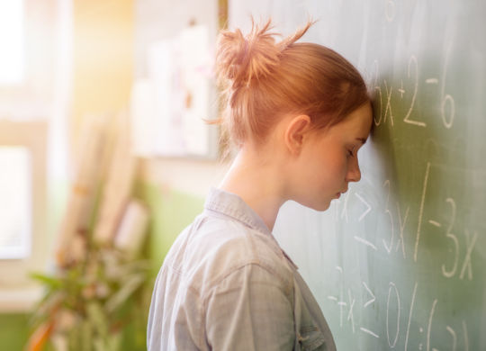 Teenager girl in math class overwhelmed by the math formula. Pressure, Education, Success concept.